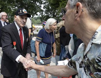 World War II veteran Lincoln Harner meets an admirer after a ceremony at the National World War II Memorial in Washington, D.C., on the 79th anniversary of the start of the D-Day invasion, Tuesday, June 6, 2023.