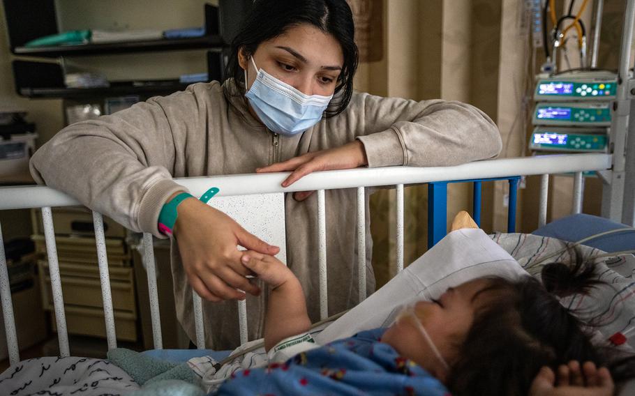 Priscilla Velazco keeps a watchful eye on her 16-month-old daughter, Emilia Zarazua, at Loma Linda University Children’s Hospital on Dec. 28. Emilia had fallen ill with respiratory syncytial virus, or RSV. People with weak immune systems are particularly at risk for RSV, along with older people. 