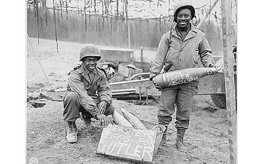 T/5 William E. Thomas and Pfc. Joseph Jackson display their message for Hitler in 1945. 