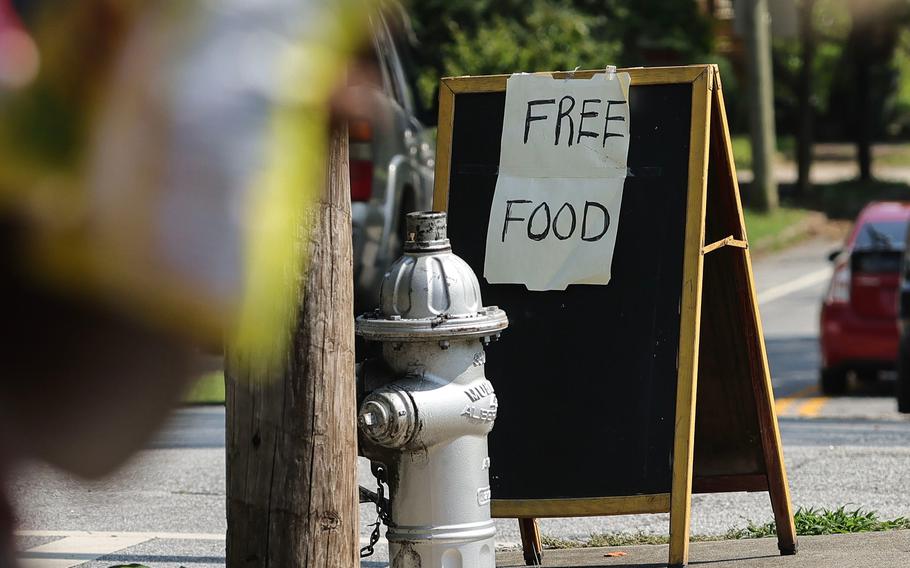 A free food sign sits on a corner in the West End neighborhood of Atlanta during a free food bank held by the Metro Atlanta Urban Farm on July 25, 2023.