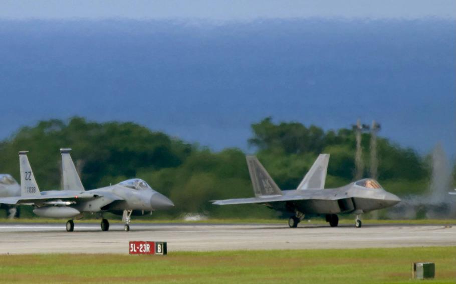 An F-15C Eagle lines up beside an F-22A Raptor at Kadena Air Base, Okinawa, Tuesday, Nov. 22, 2022. 