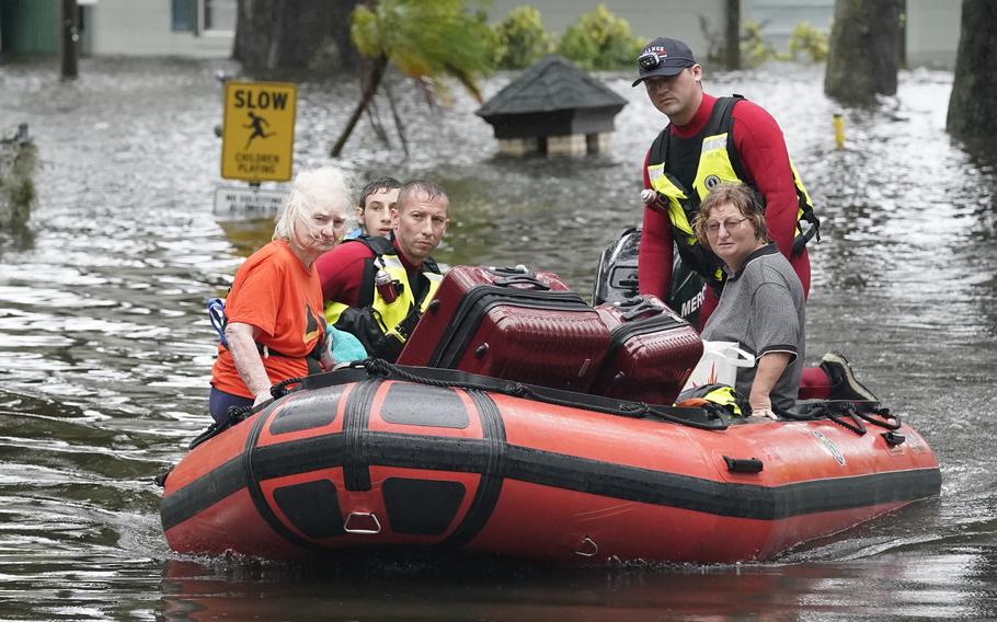 Residents are rescued from floodwaters in the aftermath of Hurricane Ian in Orlando, Fla., on Thursday, Sept.  29, 2022. 