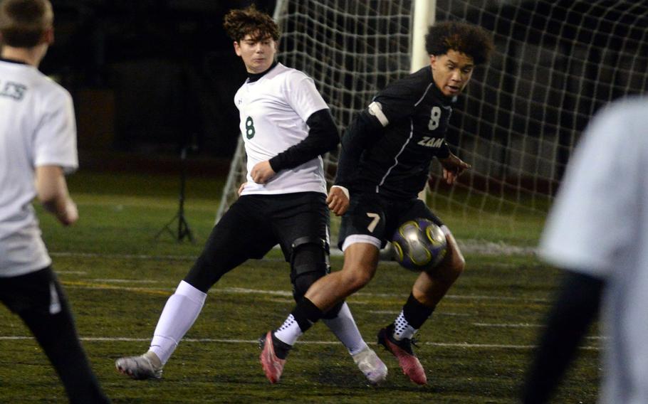 Robert D. Edgren’s Santi Castano and Zama’s Jadyn Parker tussle for the ball during Friday’s DODEA-Japan season-opening soccer match. Parker scored twice and the Trojans won 4-1.