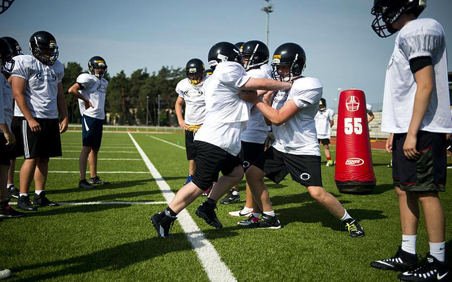 Players run defensive drills during a football camp in Kaiserslautern, Germany in 2017. Some spots are still available for a football camp set to run July 25 to July 29, 2022, at Kaiserslautern High School. 