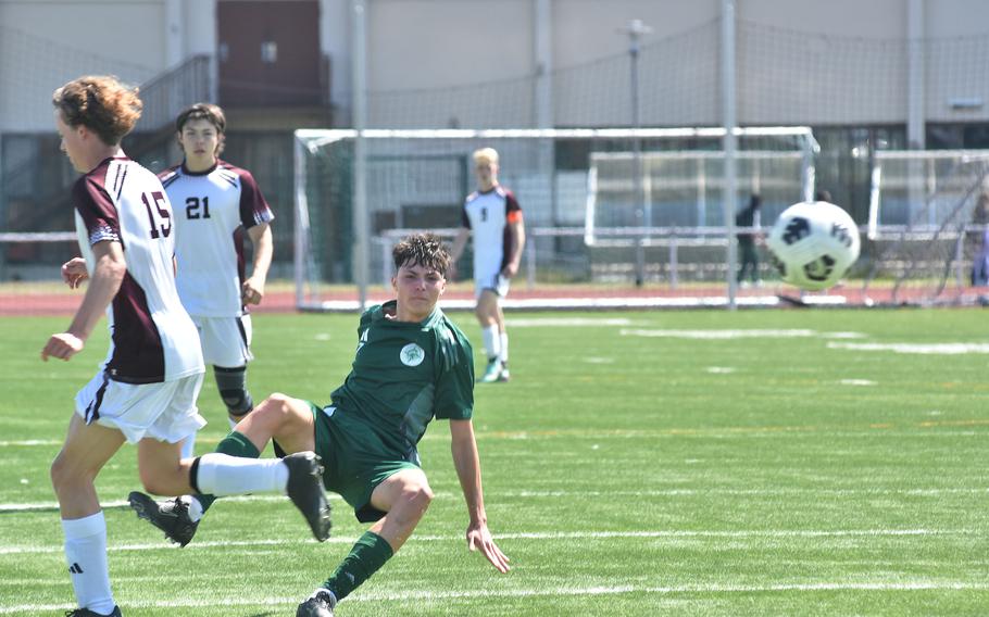 SHAPE's Jack Murrer watches his shot on goal head toward the net Monday, May 20, 2024, during the opening day of the DODEA European Division I boys soccer championships at Kaiserslautern, Germany.
