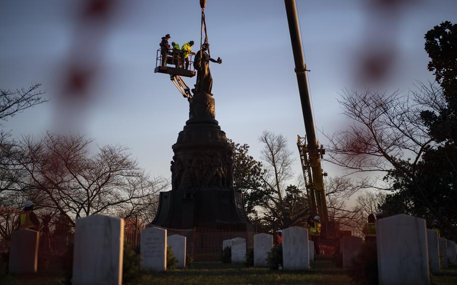 Workers remove a memorial.
