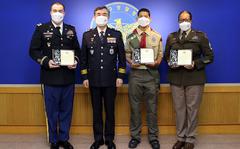 Army Maj. Gabriel Bowns, Sgt. 1st Class Gisele Schilling and Boy Scout Azizi Wilkins were recognized by South Korean police officers for alerting and escorting over a dozen people from a burning building earlier this month.