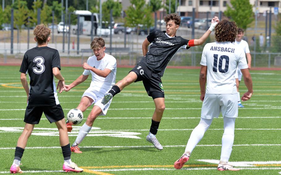 Ansbach’s Brodie Kohrs takes a shot as Alconbury’s Leonides Politis tries to block in the Division III boys final at the DODEA-Europe soccer championships in Ramstein, Germany, May 22, 2025, won by Ansbach 1-0.