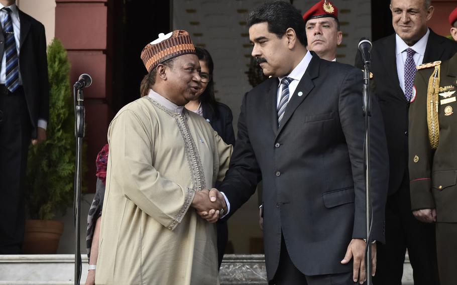 Mohammad Barkindo, secretary general of OPEC, left, and Nicolas Maduro, Venezuela’s president, shake hands after a meeting at the presidential palace in Caracas, Venezuela, in 2016. 