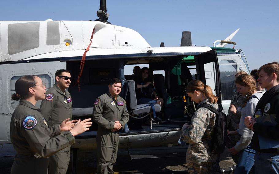 Airmen from the 459th Airlift Squadron teach students about the UH-1 Iroquois helicopter, also known as the Huey, during a Fly Girls event at Yokota Air Base, Japan, Wednesday, March 8, 2023.