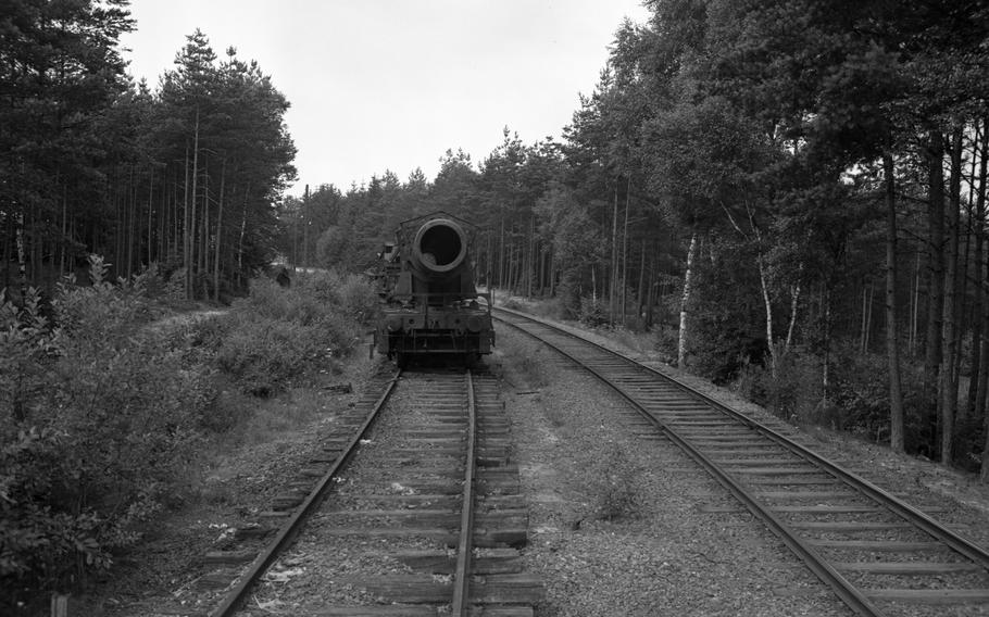A massive Nazi Germany produced railway gun is being disassembled in the woods near Grafenwöhr, Germany, by American forces in July 1949.
