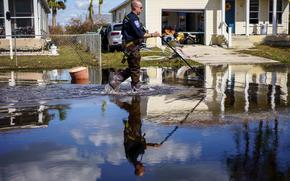 A search and rescue officer patrols a Harlem Heights neighborhood near Fort Myers Beach, Fla.