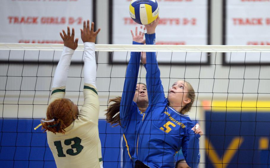 Yokota's Charlotte Rhyne and Erica Haas battle at the net with Robert D. Edgren's Genesis Miller during Saturday's DODEA-Japan volleyball match. The Panthers won in five sets, splitting their weekend series with the Eagles.