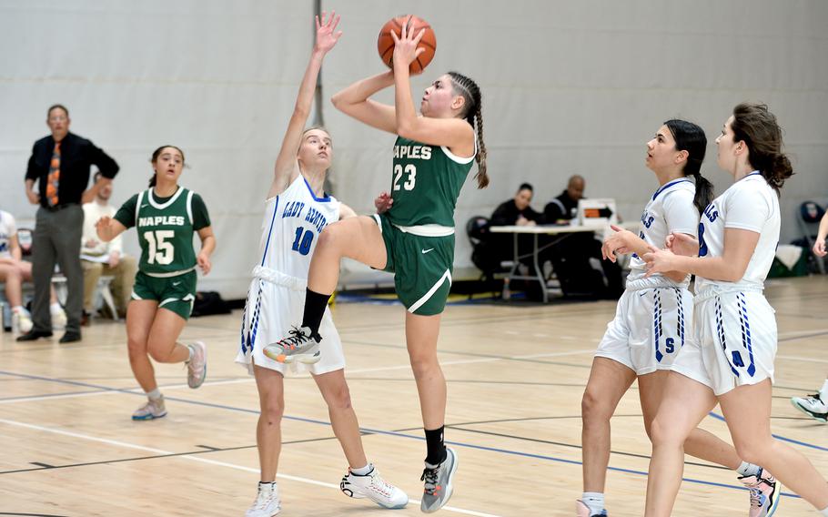 Naples' JuJu Martinez puts up a runner during a pool-play game against Rota at the Division II DODEA European Basketball Championships on Thursday at Southside Fitness Center on Ramstein Air Base, Germany. Defending is the Admirals' Sophia Dickkut, right, while trailing are Rota's Alana Geylani and Madison Lewis.