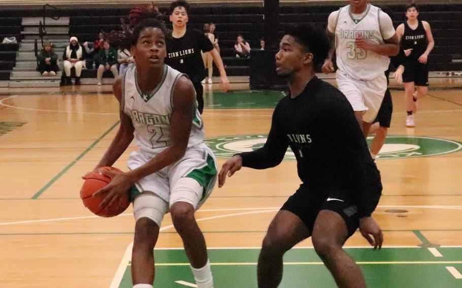 Zion Christian's Khalil Bowman waits for Kubasaki's Carlos Cadet to take a shot.