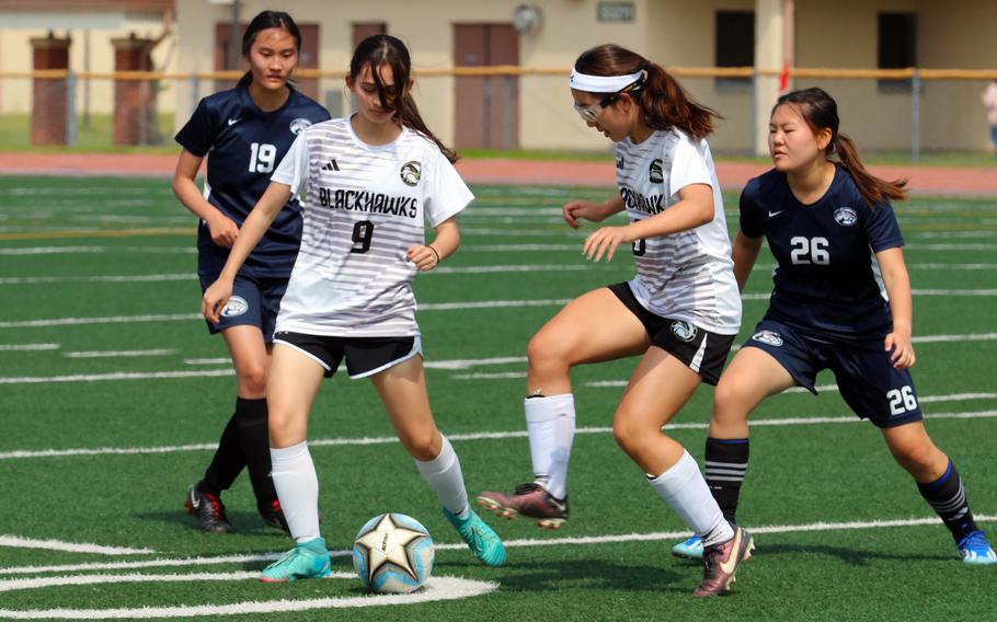 Humphreys' Callie Green and Kayla Collins play the ball against Osan's Isabella Collins and Grace Kim during Monday's quarterfinal in the Korea postseason girls soccer tournament. The Blackhawks won 8-5, but lost the semifinal later against Chadwick 6-2. Osan remains alive for fifth place, while Humphreys will play for third Saturday.