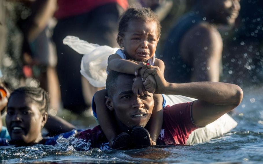 Haitian immigrants cross the Rio Grande back into Mexico from Del Rio, Texas on September 20, 2021 to Ciudad Acuna, Mexico. 