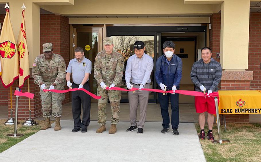 The ribbon is cut on the first of three new housing towers opening at Camp Humphreys, South Korea, Friday, May 13, 2022. 