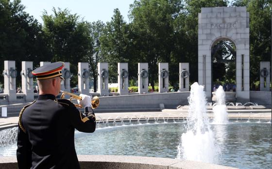 Staff Sgt. Andrew Boylan of the U.S. Army Band plays taps during a Memorial Day ceremony at the National World War II Memorial in Washington, May 30, 2022.
