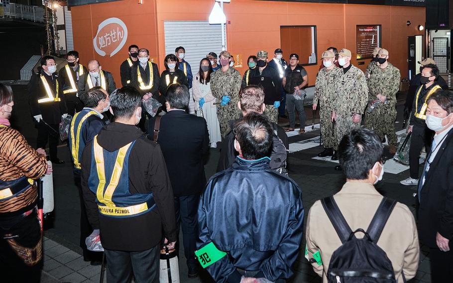 Sailors, including base commander Capt. Rich Jarrett, and locals restart monthly cleanup patrols of “The Honch,” a popular nightlife area near Yokosuka Naval Base, Japan, Friday, Nov. 11, 2021. 