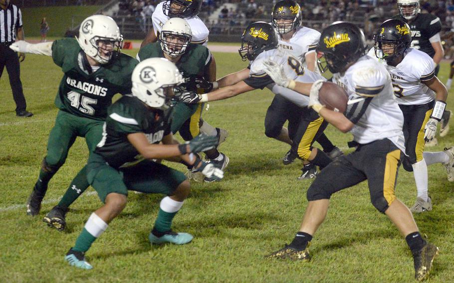 Kadena's Trent Fowler looks for running room against Kubasaki's defense.