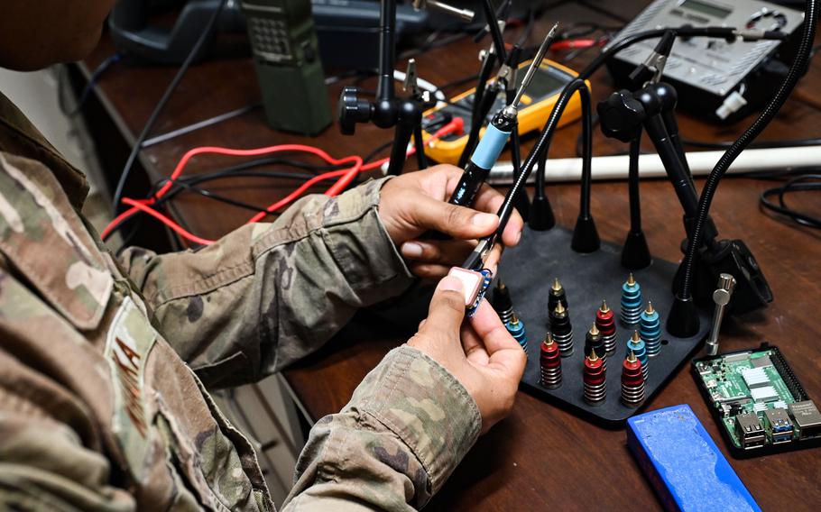 A Task Force 99 airman solders components at Al Udeid Air Base in Qatar on Oct. 28, 2022. 