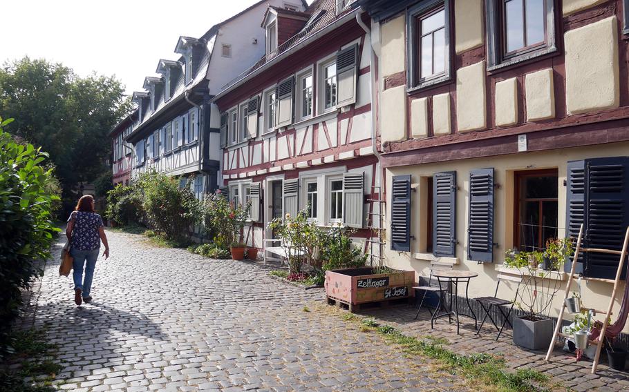 A visitor to Hoechst walks down Burggraben, a cobblestone lane across from Hoechst Palace that is lined with half-timbered houses.