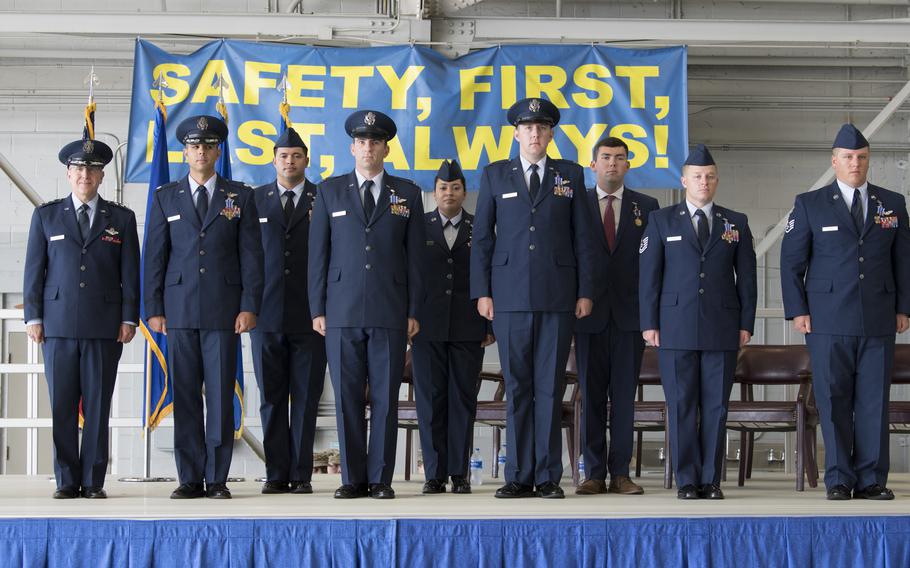 The crew of Shadow 71 pose after receiving the Distinguished Flying Cross and an Air Medal during a ceremony at Hurlburt Field, Fla., June 22, 2021. The crew received the medals for their actions to protect ground forces in Afghanistan in September 2019.