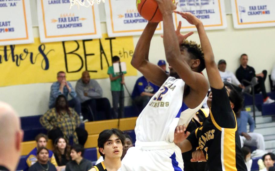 Yokota's DeShawn Bryant shoots against American School In Japan during Tuesday's Kanto Plain boys basketball game. The Panthers won 58-26.