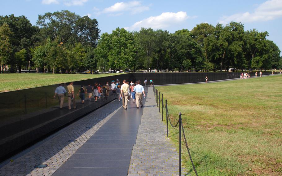Visitors walk past the Vietnam Veterans Memorial in Washington, D.C., on July 27, 2009.