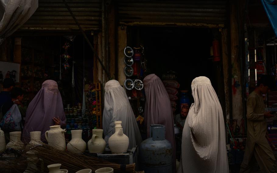 Women last month at a Kandahar market. Women have largely vanished from markets and workplaces in the city of 614,000.