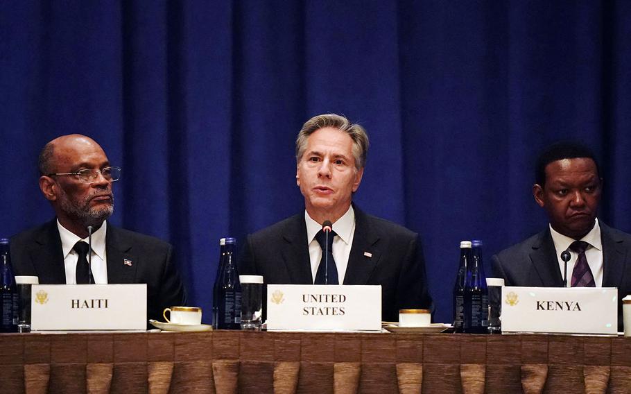 U.S. Secretary of State Antony Blinken, flanked by Haitian Prime Minister Ariel Henry, left, and Kenyan Cabinet Secretary for Foreign and Diaspora Affairs, Alfred Nganga Mutua, right, addresses diplomats during a meeting on the security situation in Haiti, on the sidelines of the 78th UN General Assembly on Sept. 22, 2023, in New York. 