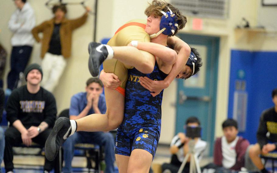 Yokota 145-pounder Brandon Christenson lifts St. Mary's Dongwoo Leem during Wednesday's Kanto Plain dual meet. Christenson won by pin in 1 minute, 10 seconds, but the Titans won the meet 40-18.
