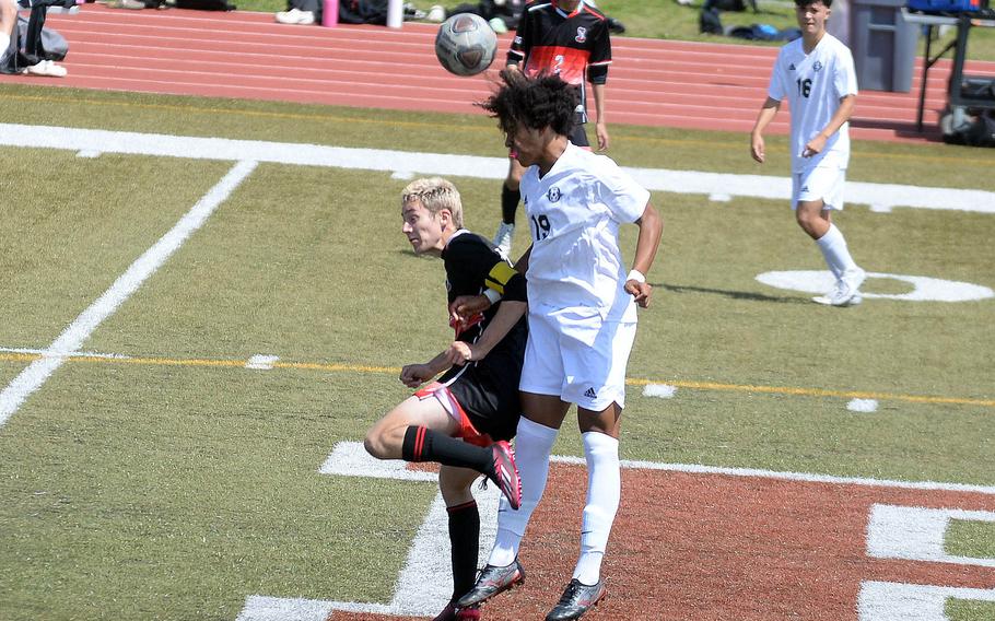 Kadena's Jelani McGhee heads the ball against E.J. King's Kai Sperl during Saturday's DODEA interdistrict boys soccer match. The Panthers won 1-0.