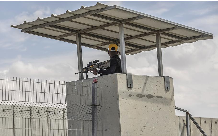 An Israeli security guard watches over the Kerem Shalom border crossing in March.