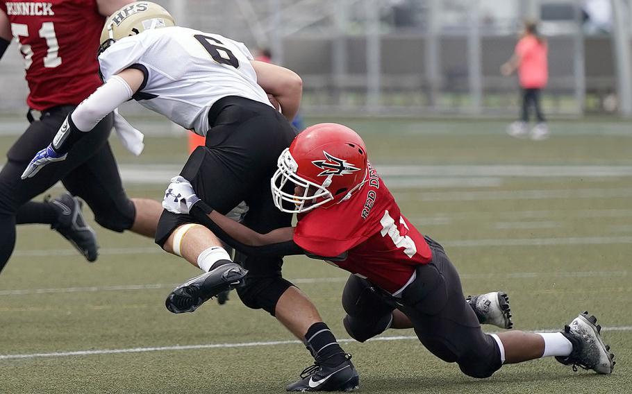 Humphreys' Luke Robinson gets wrapped up by a Nile C. Kinnick defender.