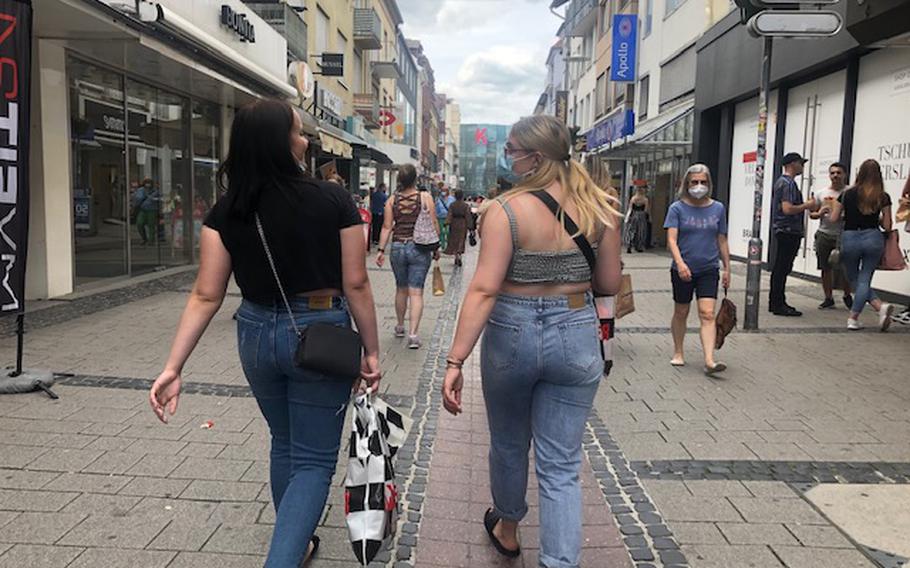 People walk past shops in the pedestrian zone in Kaiserslautern, Germany, on June 12, 2021. The state of Rheinland-Pfalz, which includes Kaiserslautern and numerous military installations, is adopting new coronavirus rules that do away with lockdowns.