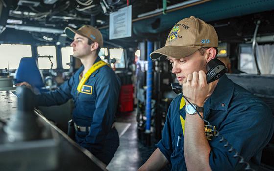  Lt. j.g. Dom Restivo, right, and Ensign Ethan Margot stand watch aboard the guided-missile destroyer USS John Finn during an exercise with the Australian and Japanese navies in the South China Sea, Feb. 7, 2024.