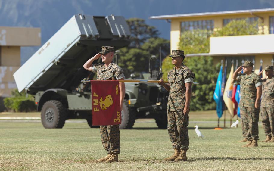 The 3rd Marine Littoral Regiment stands in front of the Navy-Marine Expeditionary Ship Interdiction System.