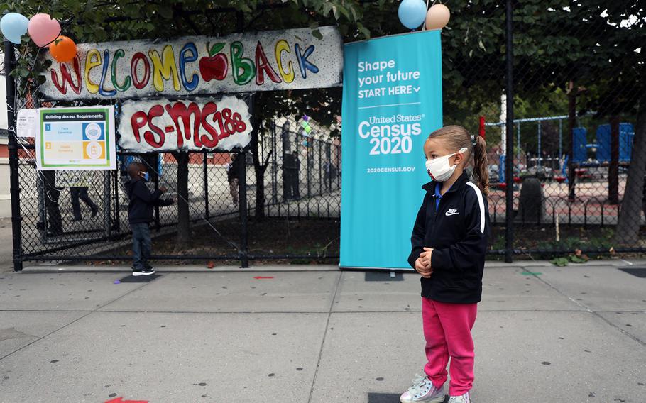 Elementary school students are welcomed back to P.S. 188 as the city's public schools open for in-person learning on Sept. 29, 2020, in New York City. Some children throughout the nation will be greeted with a new ritual when they return to school after the holidays: COVID-19 testing. 