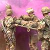 Hed: Expert Field Medical Badge, Kosovo ed., 2002

Camp Bondsteel, Kosovo, Aug. 24, 2002: Medical personnel transport an "injured" soldier through an obstacle course Aug. 22, 2002. As Staff Sgt. Jose Nuques emerges from the smoke, he helps his team carry a patient over a wall. Pictured from left to right are: 1st Lt. Stephanie Martinson, Pfc. Melanie Bauguess (white stripe on helmet) and Staff Sgt. Genaro Silvas. The four were among more than 130 soldiers who attempted to earn the prestigious badge, the first time it has been available to medics and other medical personnel deployed to Kosovo. Om average, only about 15 - 20 percent of each class makes it. 

Read the full account by Kevin Dougherty here. 