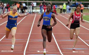 Sigonella’s Rickalia Goss crosses the finish line in the girls 100-meter dash ahead of Wiesbaden’s  Lana Winters, left, and Kaiserslautern’s Trinity Seaberry. Goss’s winning time at at the 2025 DODEA-Europe track and field finals, in Kaiserslautern, Germany, was 12.33 seconds.