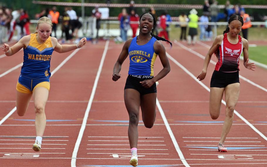 Sigonella’s Rickalia Goss crosses the finish line in the girls 100-meter dash ahead of Wiesbaden’s  Lana Winters, left, and Kaiserslautern’s Trinity Seaberry. Goss’s winning time at at the 2025 DODEA-Europe track and field finals, in Kaiserslautern, Germany, was 12.33 seconds.
