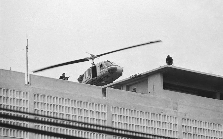 This black and white photograph shows a U.S. Marine helicopter as it takes off from a helipad on top of the American Embassy in Saigon, Vietnam.
