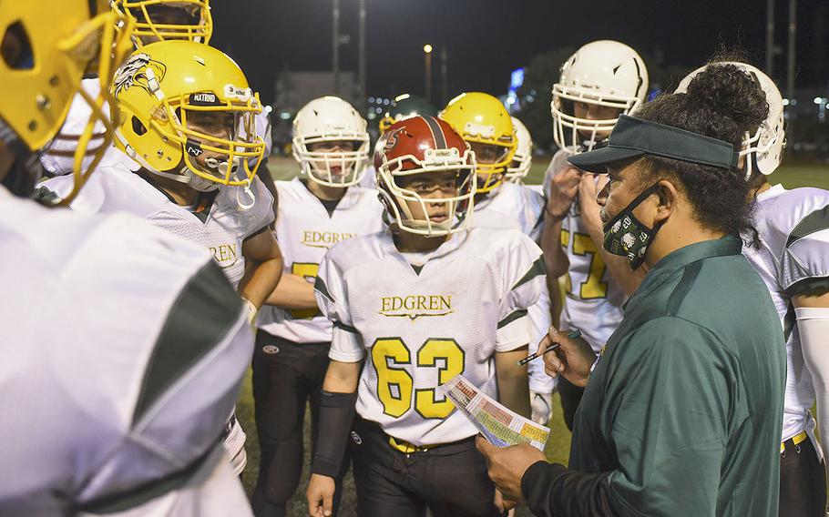 Robert D. Edgren players get coaching during a time out at the homecoming game between Edgren and Yokota Friday, Nov. 5, 2021.