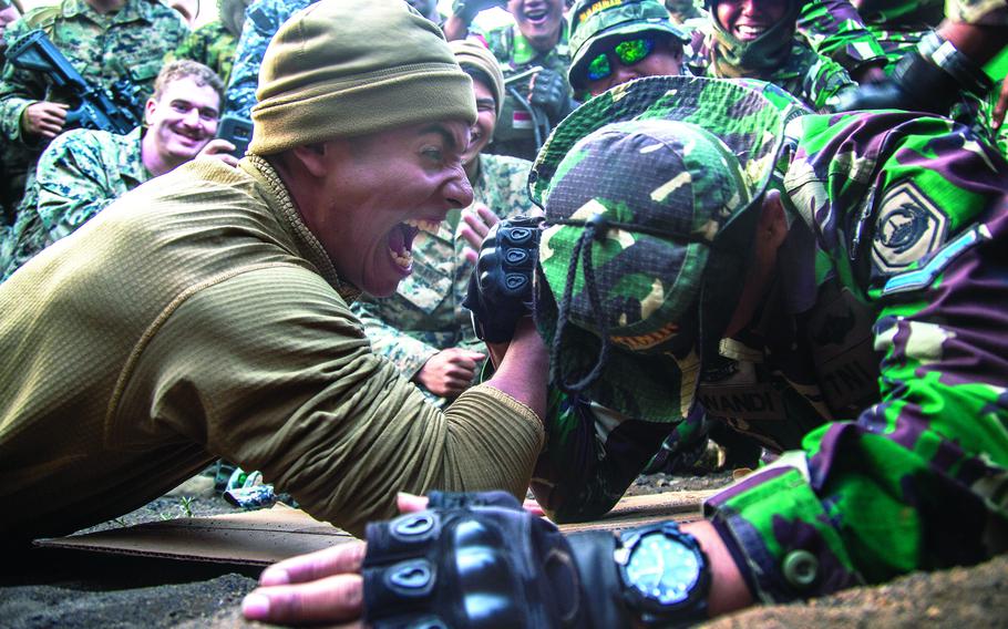 U.S. and Indonesian marines arm wrestle during the Rim of Pacific exercise at Pohakuloa Training Area, Hawaii, July 15, 2018.