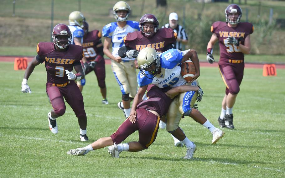 Wiesbaden Warriors’ Angel Contreras picks up a short gain on first down before being wrapped up by Vilseck's Gabriel Morell. 