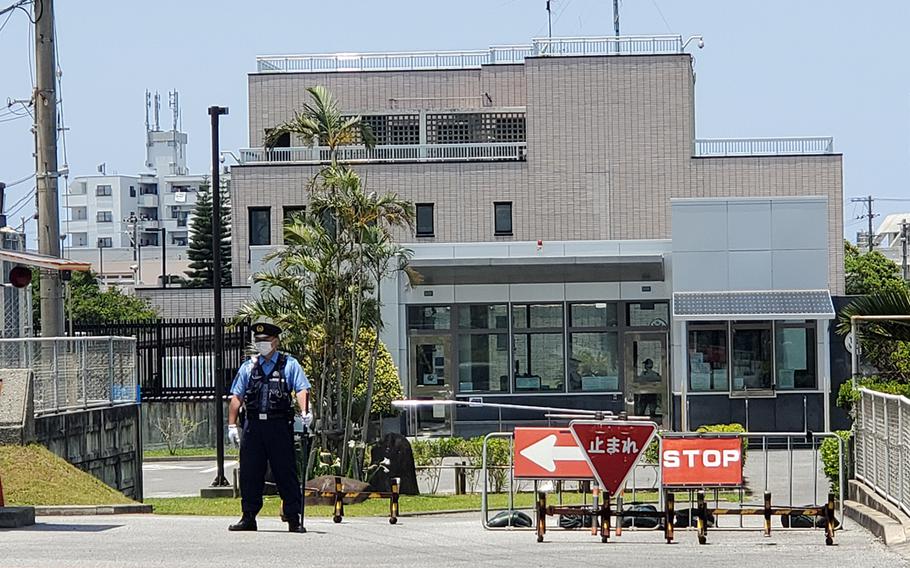 A Japanese police officer stands guard outside the U.S. Consulate in Urasoe, Okinawa, Tuesday, May 16, 2023