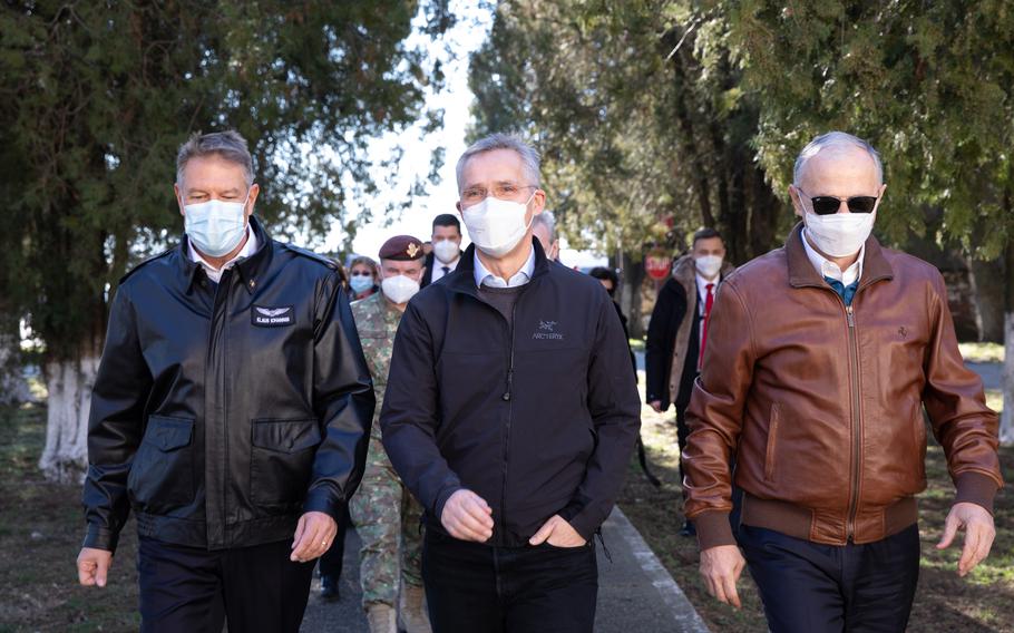 From left, Romanian President Klaus Iohannis meets with NATO Secretary-General Jens Stoltenberg and NATO Deputy Secretary General Mircea Geoana at Mihail Kogalniceanu Military Base, Romania, Feb. 11, 2022. Stoltenberg said the alliance is considering a new multinational battlegroup to be stationed in the country.