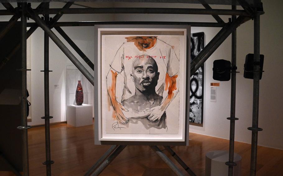 Fahamu Pecon’s “Real Negus Don’t Die: Thug” from 2013 on display at “The Culture: Hip Hop and Contemporary Art in the 21st Century” at the Schirn in Frankfurt, Germany. It shows a young man looking down at his T-shirt with a portrait of the murdered rap star Tupac Shakur on it. 